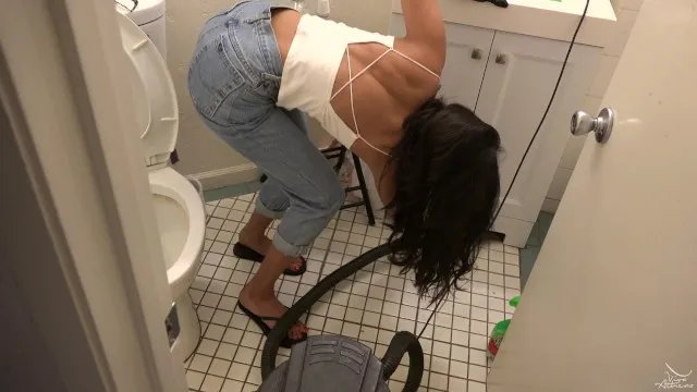 Desi bombshell vacuuming bathroom in crop top and jeans
