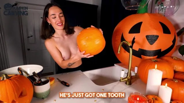 Hot topless milf carves pumpkin